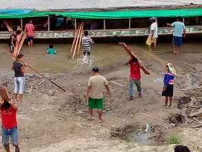 Community members work together to unload the wood