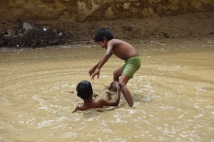 Brothers Playing In Puddle