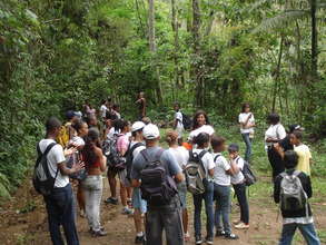 Inside the forest. Teacher speaking to students.