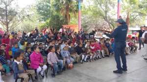 Victor Perez leading students in song