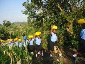 NVSS students carrying water in jerry cans