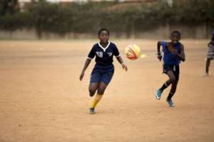 Mambo, a U14 Dolphin, competes for the ball