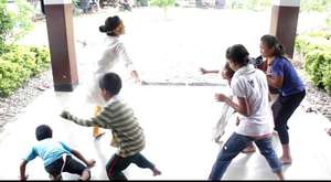 Kids playing with one of the team members