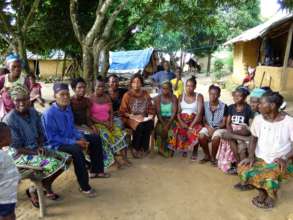 Sahadatu (center) meets with families in Kenema.