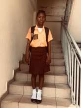 Student with new uniform and supplies
