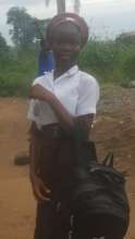 Zainab with her new uniform and school supplies.