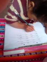 girls do lessons at home..learning to write