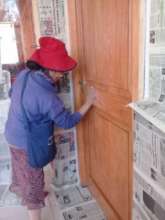 Parents help school maintenance-painting doors