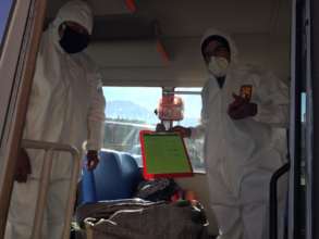 Simeon & Teacher in Hazmat on bus to deliver food
