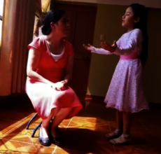 Student reciting her poem for her mother