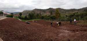 Parents prepare soil to plant veggies for meals