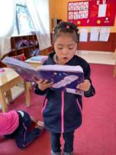 Proudly she reads her own poem