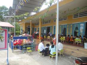 Community leaders talk safe water at a preschool