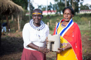 Indigenous women with an energy efficient stove.