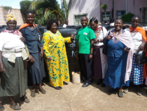 Women receive water storage tanks