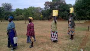 Women wait to gather water.