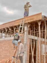 Board member Romi scaling the makeshift ladder