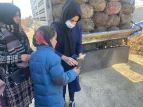 Female staff checks beneficiary's reference code