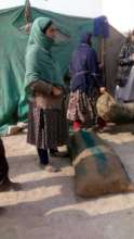 Women receiving sacks of coal