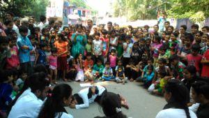 Community youth performing a street play around DV
