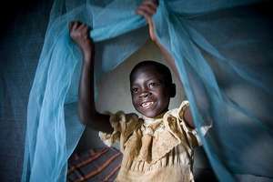 A child is protected from malaria-carrying mosquit