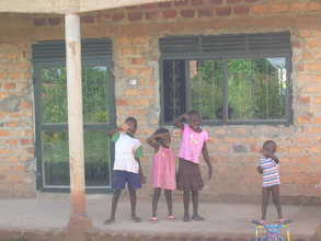 Children standing infront of house