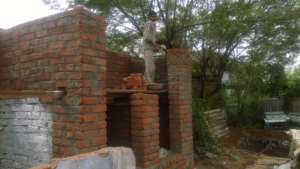 Toilet construction in progress in Amit garage