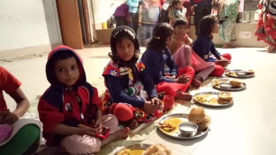 Children while having lunch on Saraswati Pooja