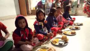 Children while having lunch on Saraswati Pooja