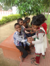 Sisters tie bands on their brothers wrist
