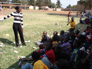 Peer educator Ruth Mueni debriefs a game about discrimination