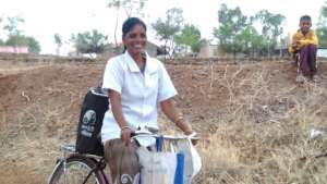 Nita on her bicycle with the nitrogen container 1