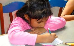 Girl doing her homework at La Casa de Panchita
