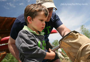 Father son collect macroinvertebrates