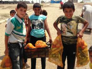 Children carrying bags of vegetables.