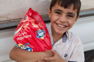 Boy with items from a food pack