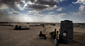 Children fetch water from a waterhole in Za'atari