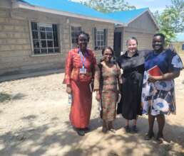 WISER Team in front of volunteer houses