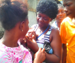 Fatmata, a facilitator, administering the vaccine