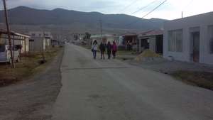Girls walk down a street in Tserovani