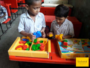 Children exploring ways to stack blocks