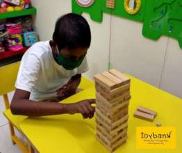 A child plays Jenga at Play2Smile partner hospital