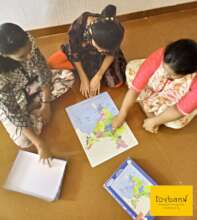 Children learning Indian geography through puzzle