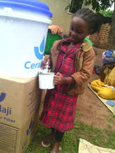 Achild drws water from the new water purifier