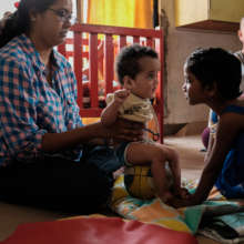 Infants with special needs receive physiotherapy