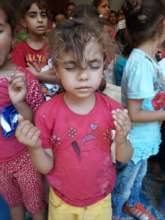 Children praying for the coronavirus to end