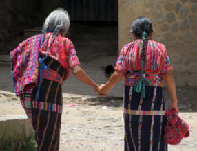 Two elderly leave the center holding hands