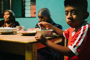 Rolando eating at the San Jorge Feeding Center