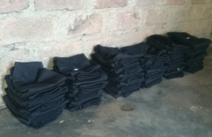 Stitched Ladies Slacks Stacked in Slum House