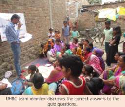 UHRC team member discusses answers with women